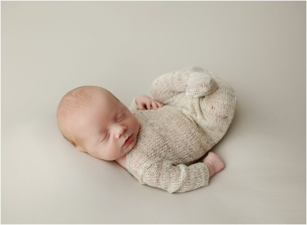 Newborn baby in knitted romper