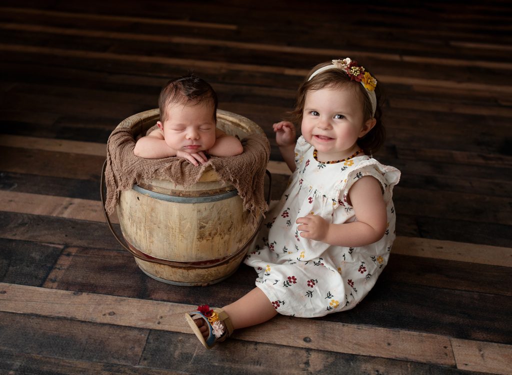 Baby in bucket with sibling pose